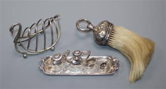 A late Victorian novelty silver swan shaped toastrack Birmingham, 1898, a silver mounted brush and 1970s silver miniature tea set.